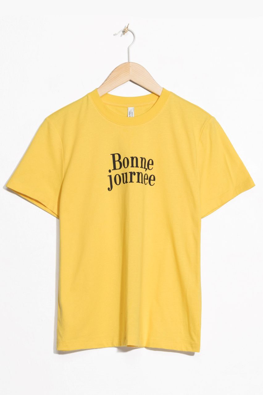 Clothing, T-shirt, White, Yellow, Sleeve, Active shirt, Top, Font, Outerwear, Crop top, 