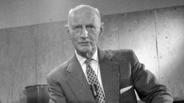 otto frank looks at the camera, he stands in a suit jacket, dress shirt and patterned tie