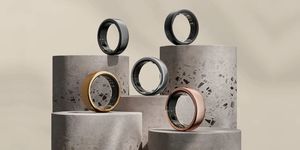 five sleep tracking oura rings in different colours presented on artistic blocks