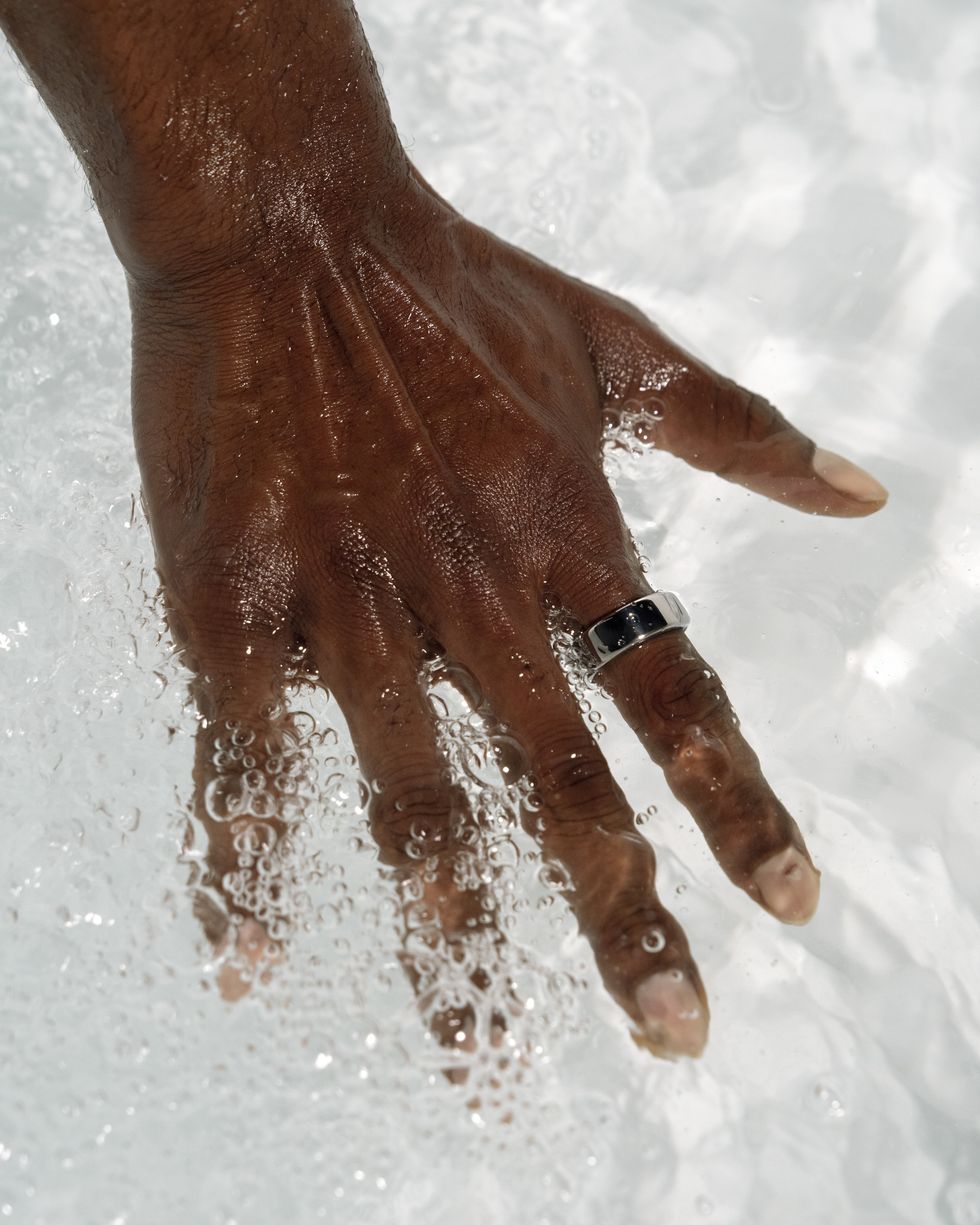 woman's hand submerged in water wearing oura ring