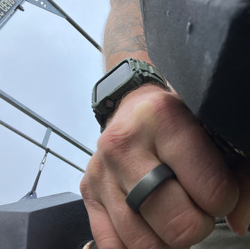 the oura smart ring on a table and a man holding a dumbbell wearing the oura smart ring