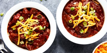 outback steakhouse tasmanian chili topped with shredded cheese and sliced green onions