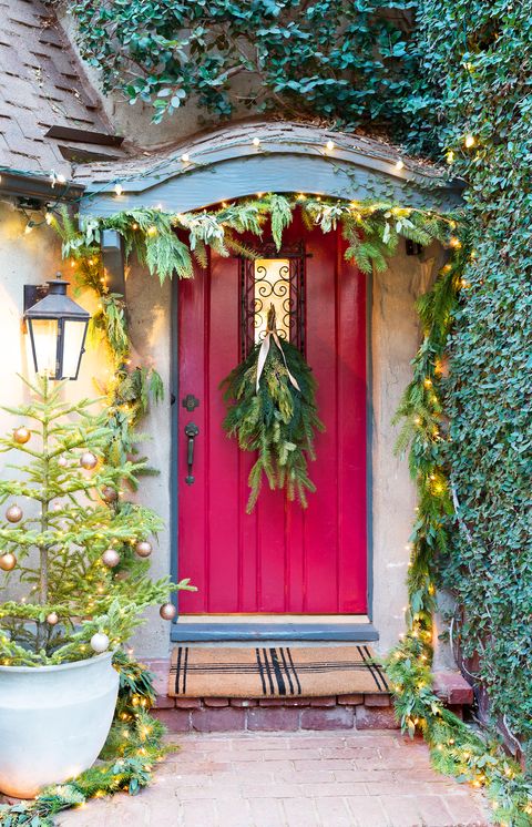 red front door decorated for the holidays