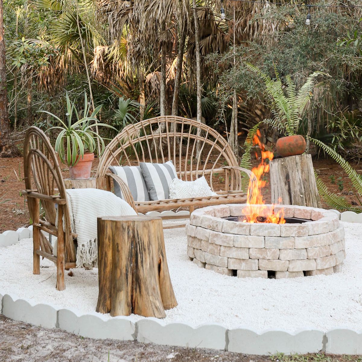 Outdoor fire pit in a garden with wicker furniture