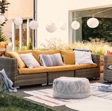 bohemian outdoor living setup with couch pouf carpets and table