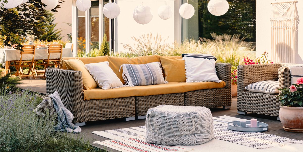bohemian outdoor living setup with couch pouf carpets and table