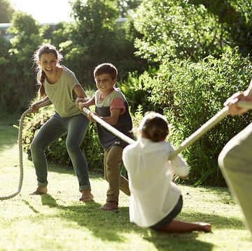 Outdoor games for kids - Family playing tug-of-war in park