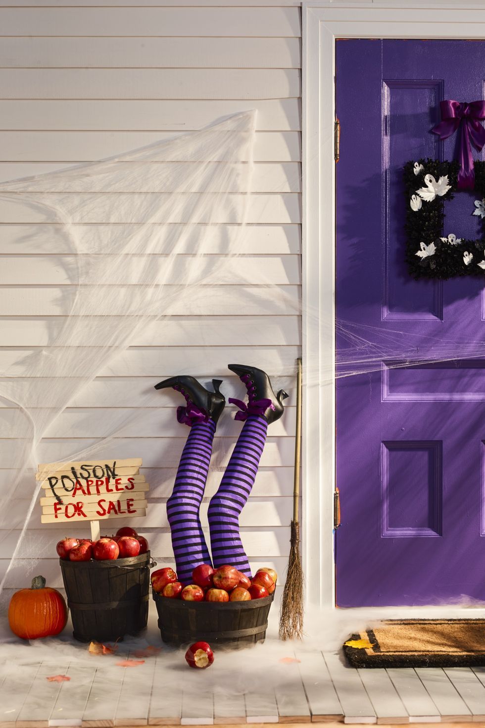 diy outdoor halloween decorations, witch legs in a bucket of apples