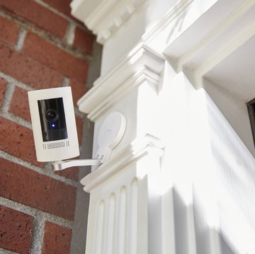 a outdoor home security smart home technology camera looking directly into camera with recording light on