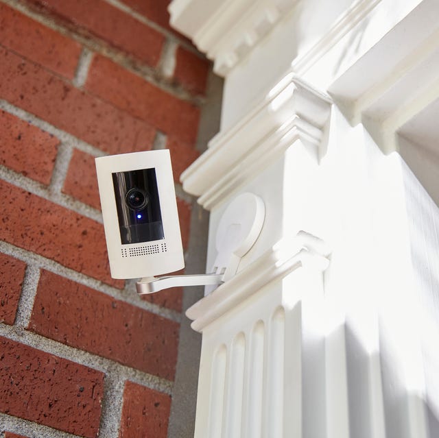 A outdoor home security smart home technology camera looking directly into camera with recording light on. a outdoor home security smart home technology camera looking directly into camera with recording light on