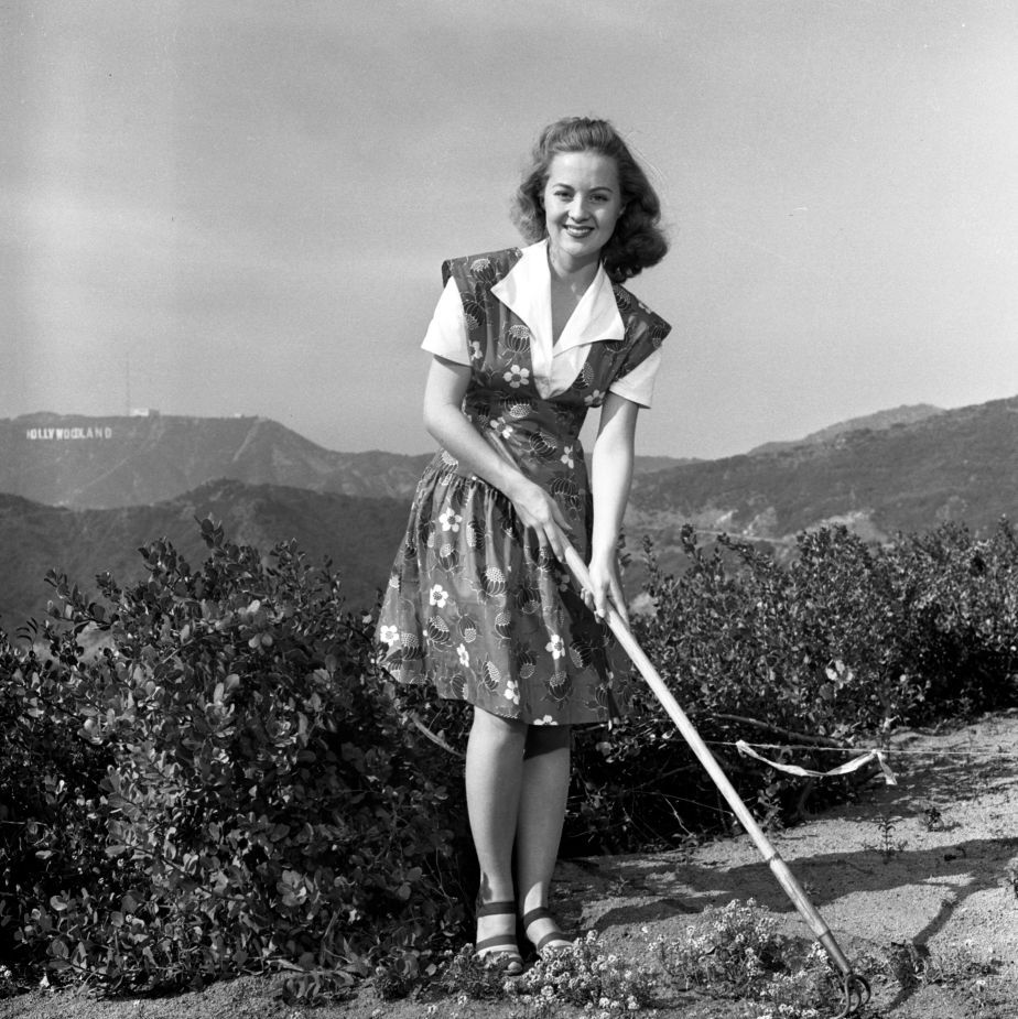 outdoor portrait of cbs radio actress sharon douglas (her stage name), born rodanelle rader. the hollywoodland sign is in far background. she portrays character terry burton on the second mrs. burton, a cbs radio soap opera. image dated december 1, 1941. (photo by cbs via getty images)