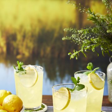 ouzo lemonade in glasses with mint and lemon garnishes