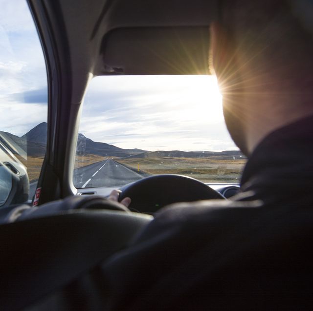 over the shoulder view of a man driving  the ring road in iceland