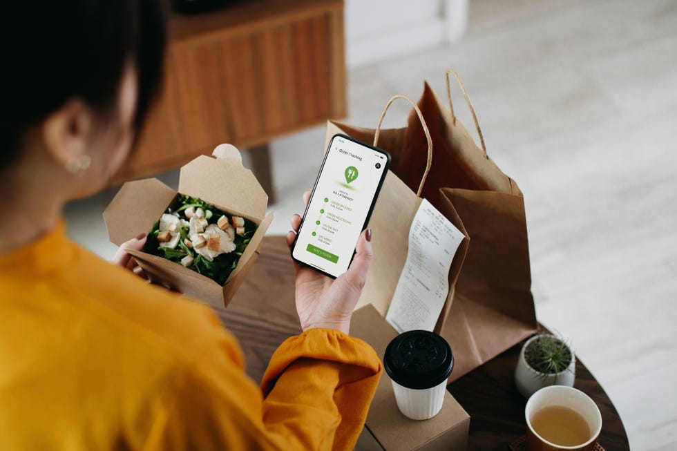 woman ordering home delivery takeaway food with mobile app