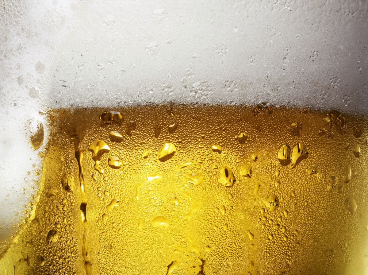 overfull glass of beer with condensation