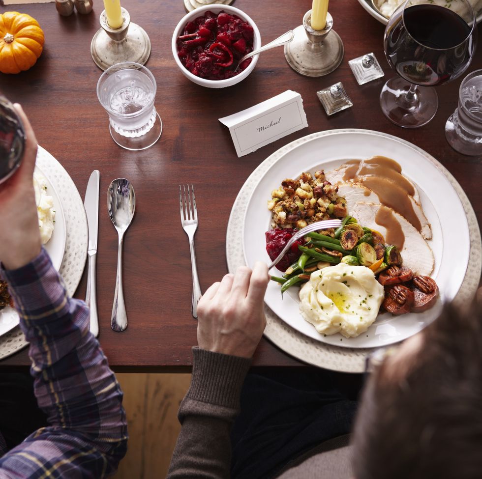overhead of two men eating holiday meal
