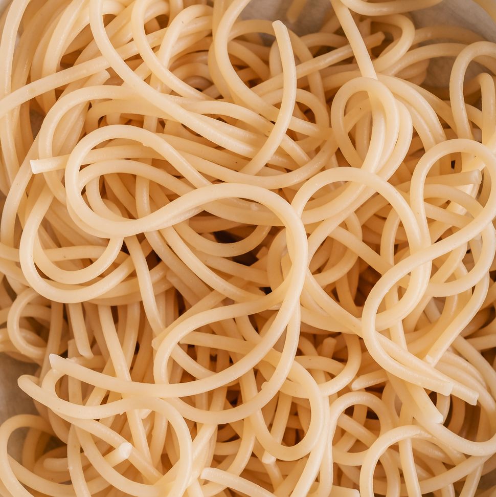 overhead view of a bowl of cooked spaghetti without sauce