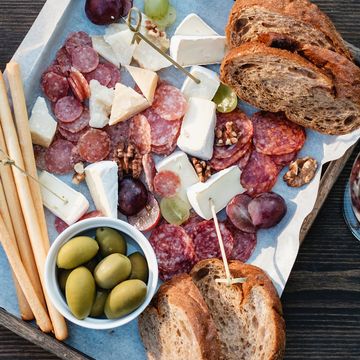 overhead view of antipasto and red wine on a table