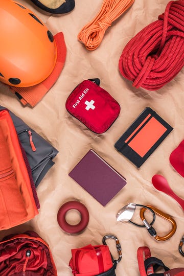 overhead view of climbing equipment with climbing helmet, first aid kit and climbing ropes