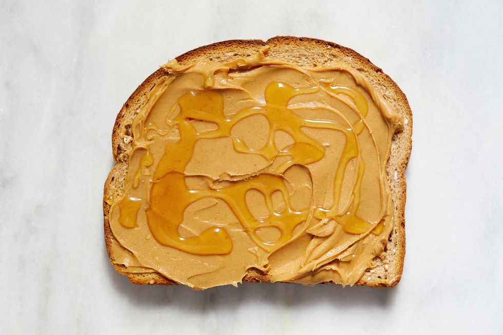 overhead view of toast with peanut butter and honey