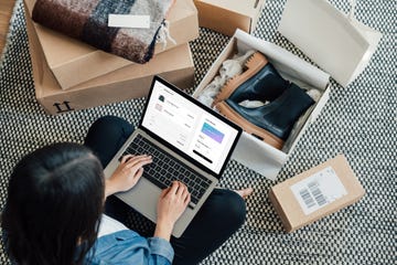overhead view of young woman doing online shopping with laptop