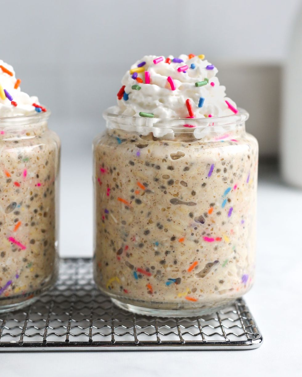 birthday cake overnight oats with whipped cream and rainbow sprinkles