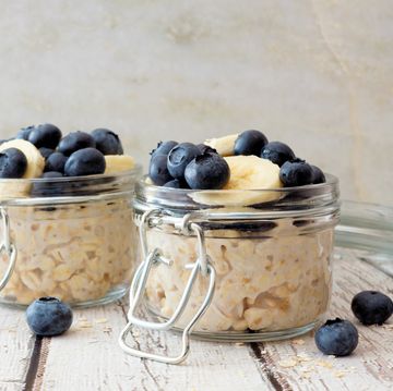 Overnight oats with blueberries and bananas on a white wood background