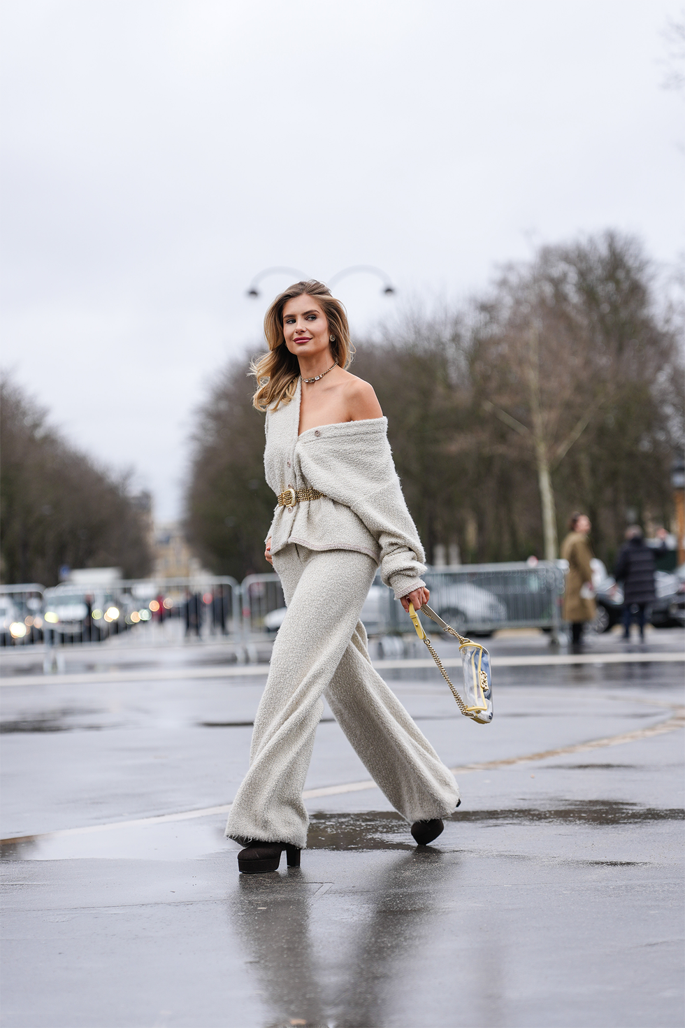 paris, france january 28: xenia adonts wears silver necklace, light gray oversized chanel tweed cardigan, light brown suede belt, light gray baggy chanel tweed pants, light yellow transparent chanel bag, outside chanel, during the haute couture spring/summer 2025 on january 28, 2025 in paris, france. (photo by edward berthelot/getty images)