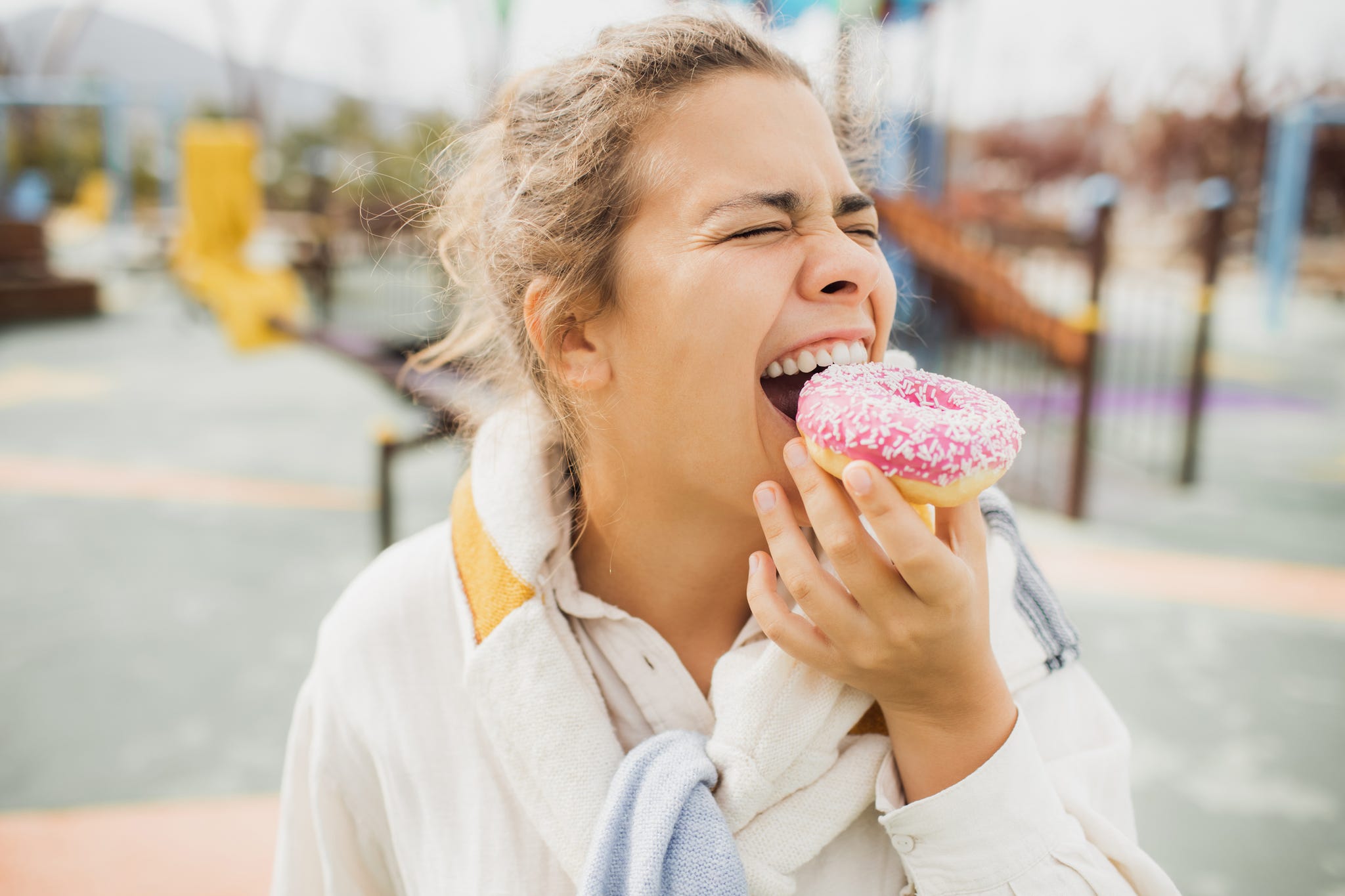 happy woman biting donut close up