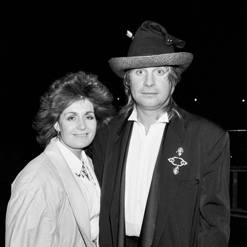 a woman and a man stand together and pose for a photo