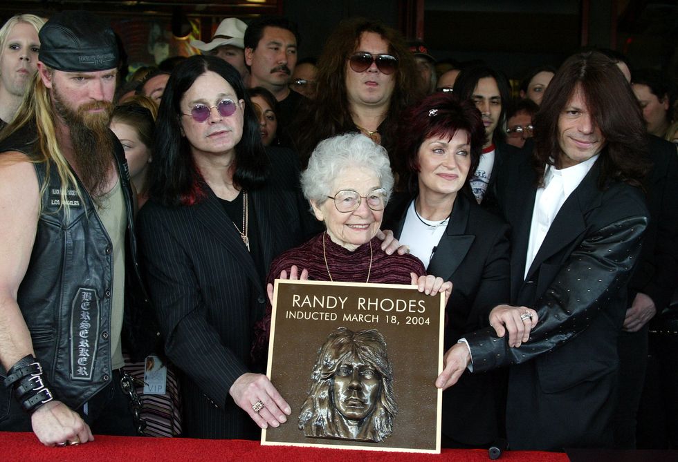 The mother of Randy Rhoads, Delores Rhoads, along with (L-R) Zakk Wylde, Ozzy Osbourne, Yngwie Malmsteen, Sharon Osbourne and Rudy Sarzo attend the ceremony in which the guitarist was honored posthumously and inducted into the Hollywood Rockwalk on March 18, 2004, in Hollywood, California