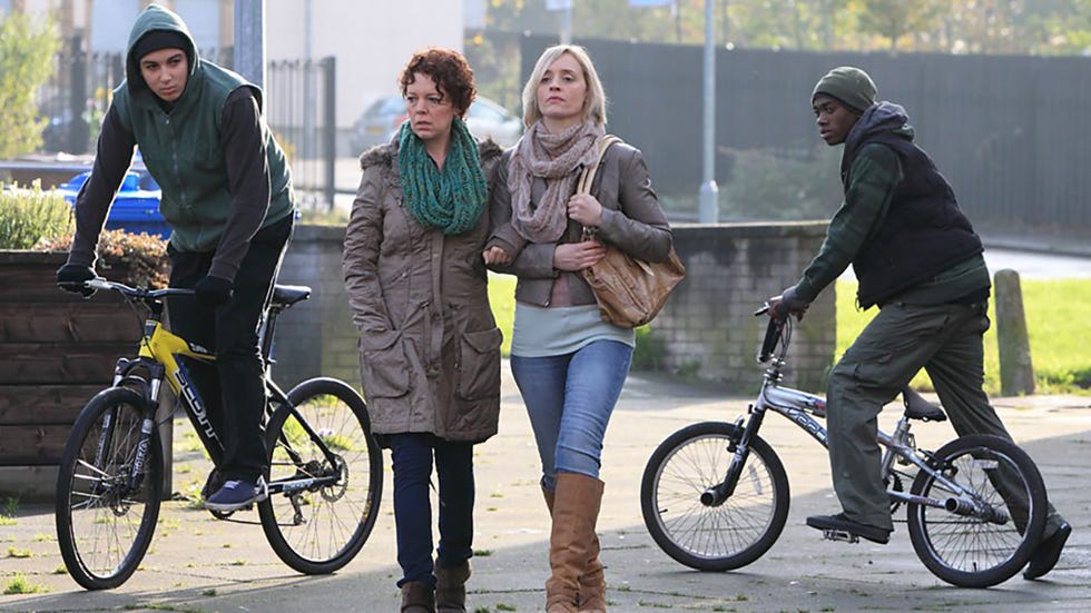 group of people engaging in social interaction outdoors with cyclists in the scene