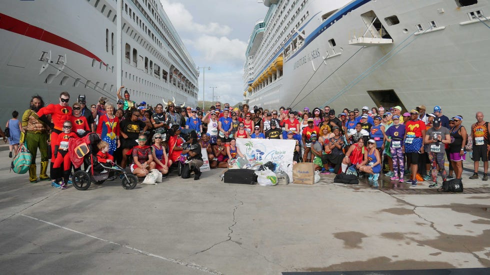 Runners pause for a photo in between cruise ships at a Run For Fun Cruise.