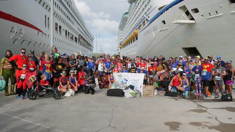 Runners pause for a photo in between cruise ships at a Run For Fun Cruise.