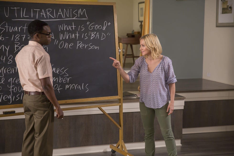 a man and a woman writing on a chalkboard