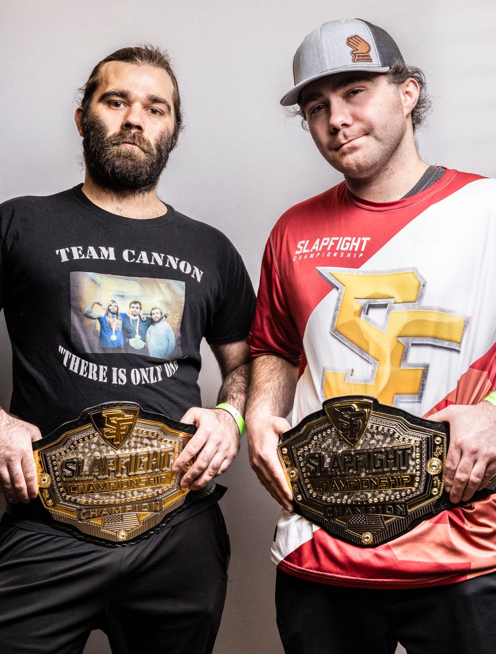 a couple of men holding trophies