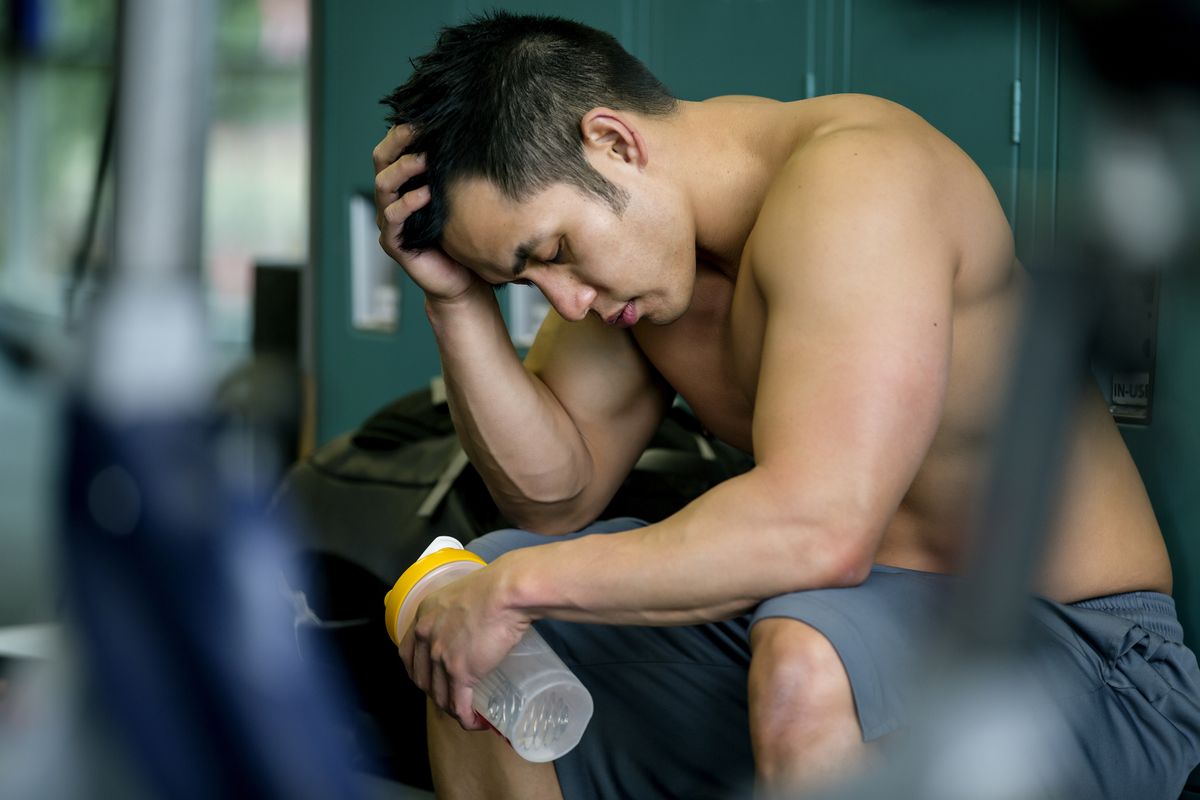 Pacific Islander man resting in gym