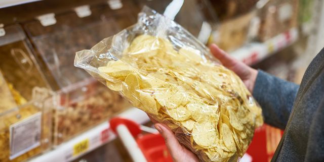 Packing of potato chips in hand in store