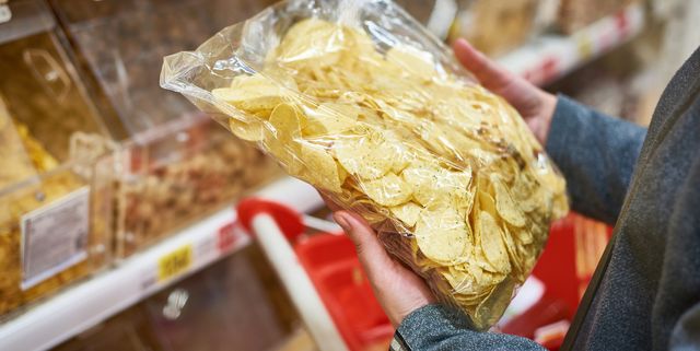 Packing of potato chips in hand in store