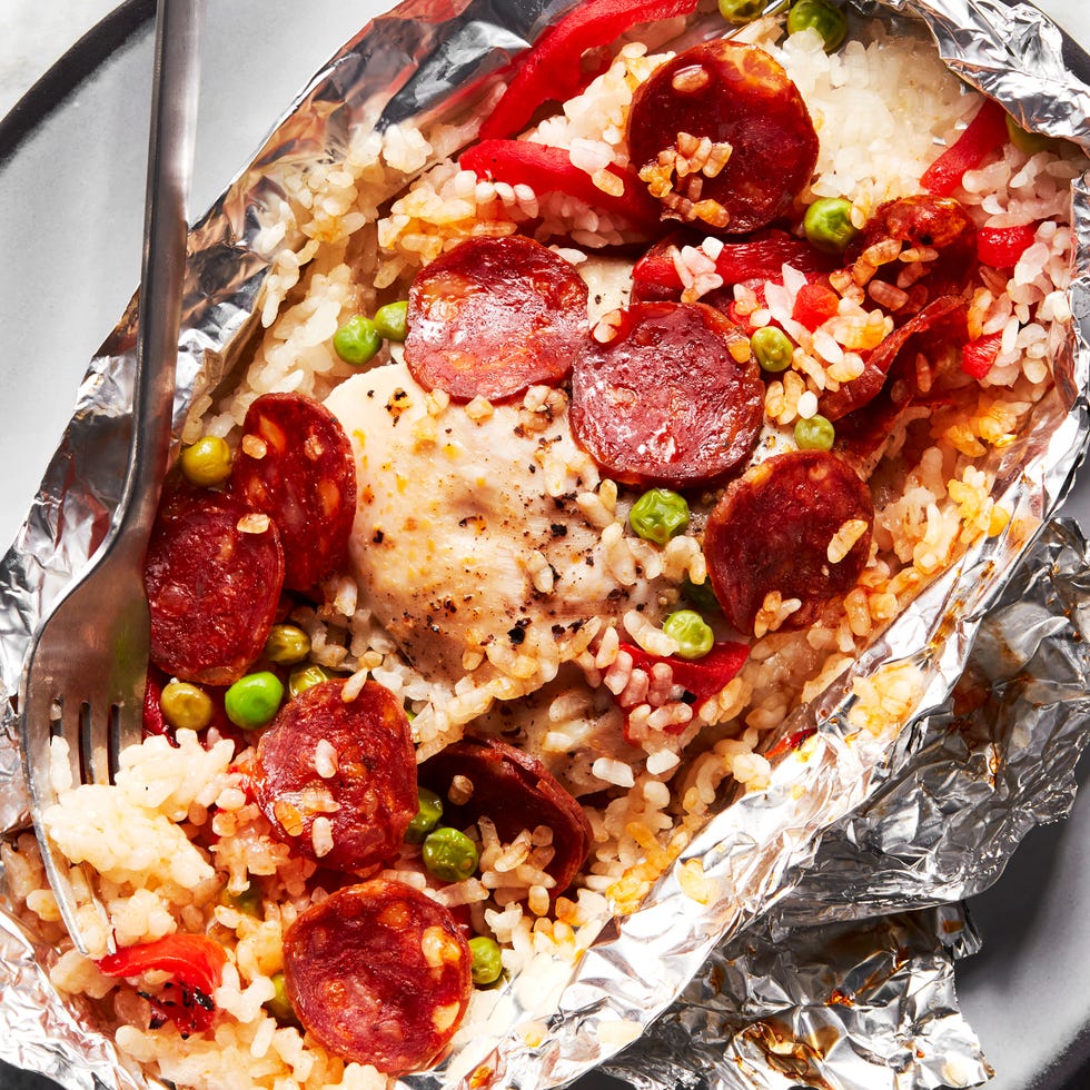 foil packs filled with rice, peas, pepperonis, and peppers