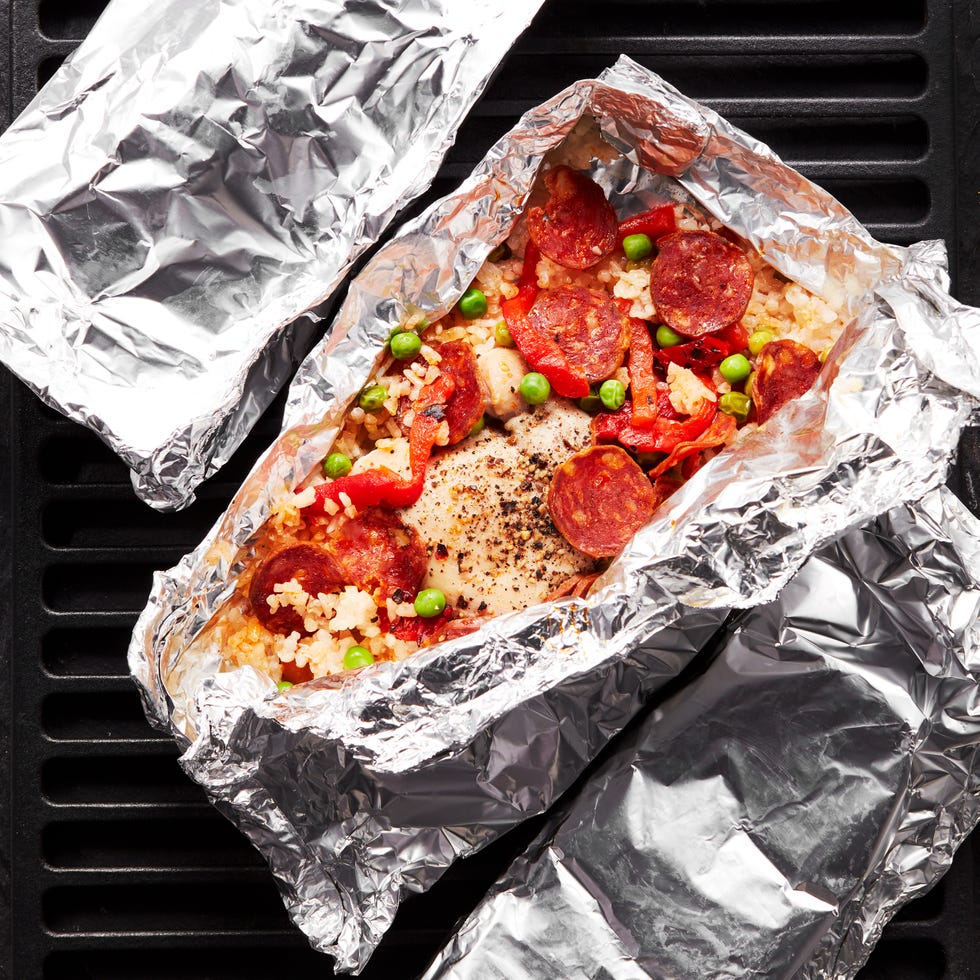 foil packs filled with rice, peas, pepperonis, and peppers