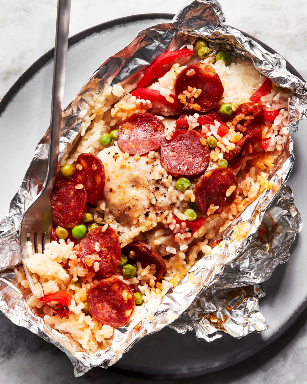 foil packs filled with rice, peas, pepperonis, and peppers