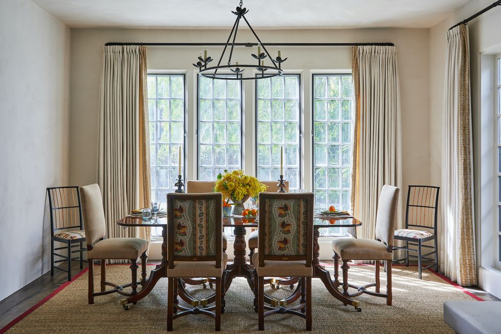 a dining room with a chandelier and a table with chairs