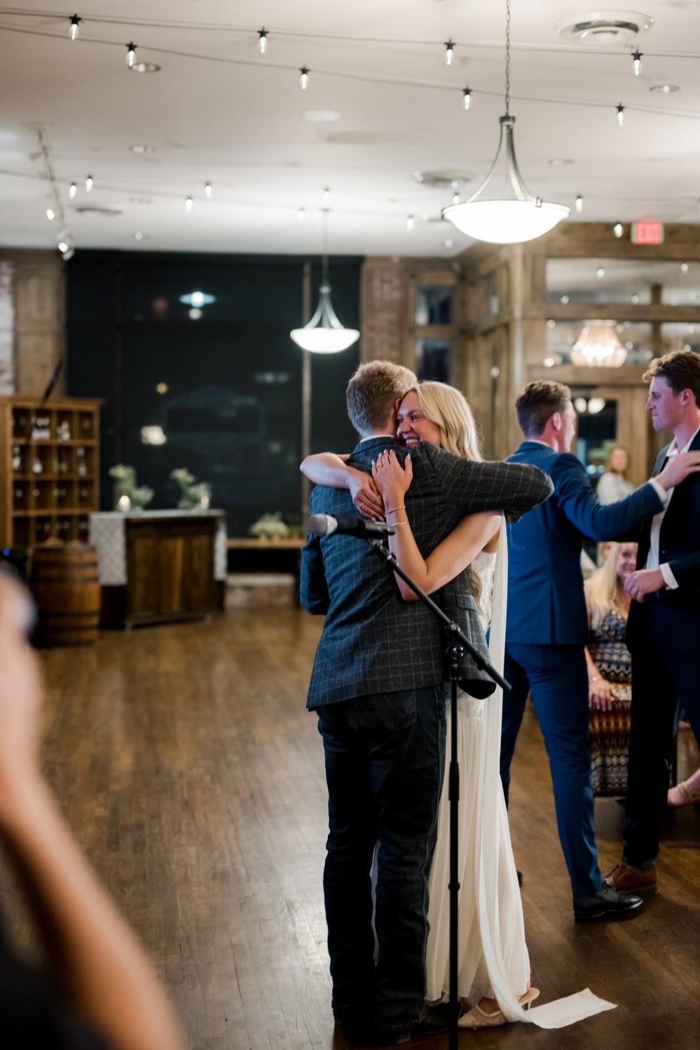 Paige Drummond and Ladd Drummond Two individuals kiss in a warm moment during a social gathering