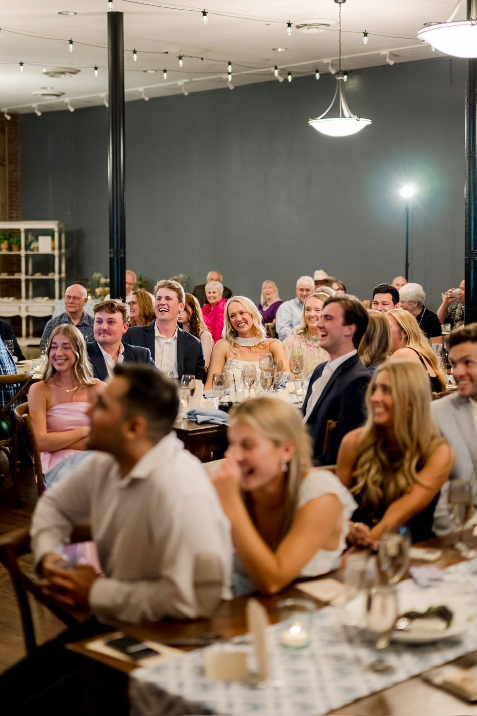 Wedding by Paige Drummond group of people attending a gathering in a dining room