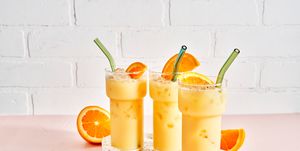 painkiller cocktails garnished with oranges on a tray