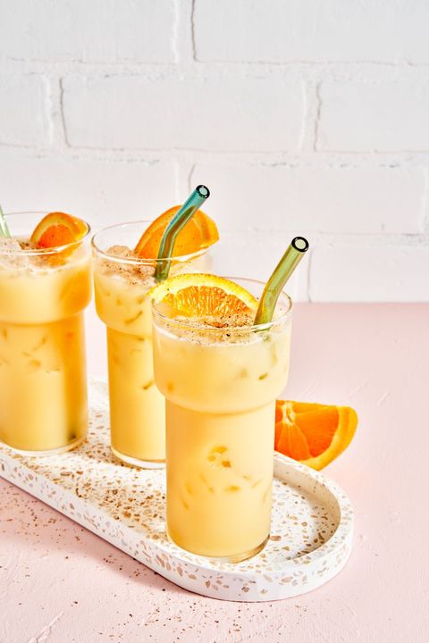 painkiller cocktails garnished with orange slices on a tray