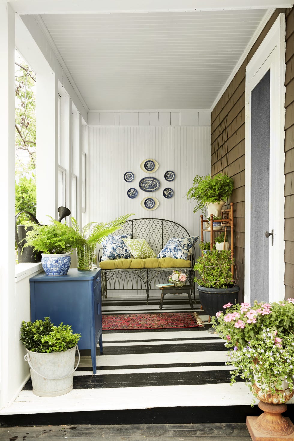 porch with painted floors in a black and white stripe pattern
