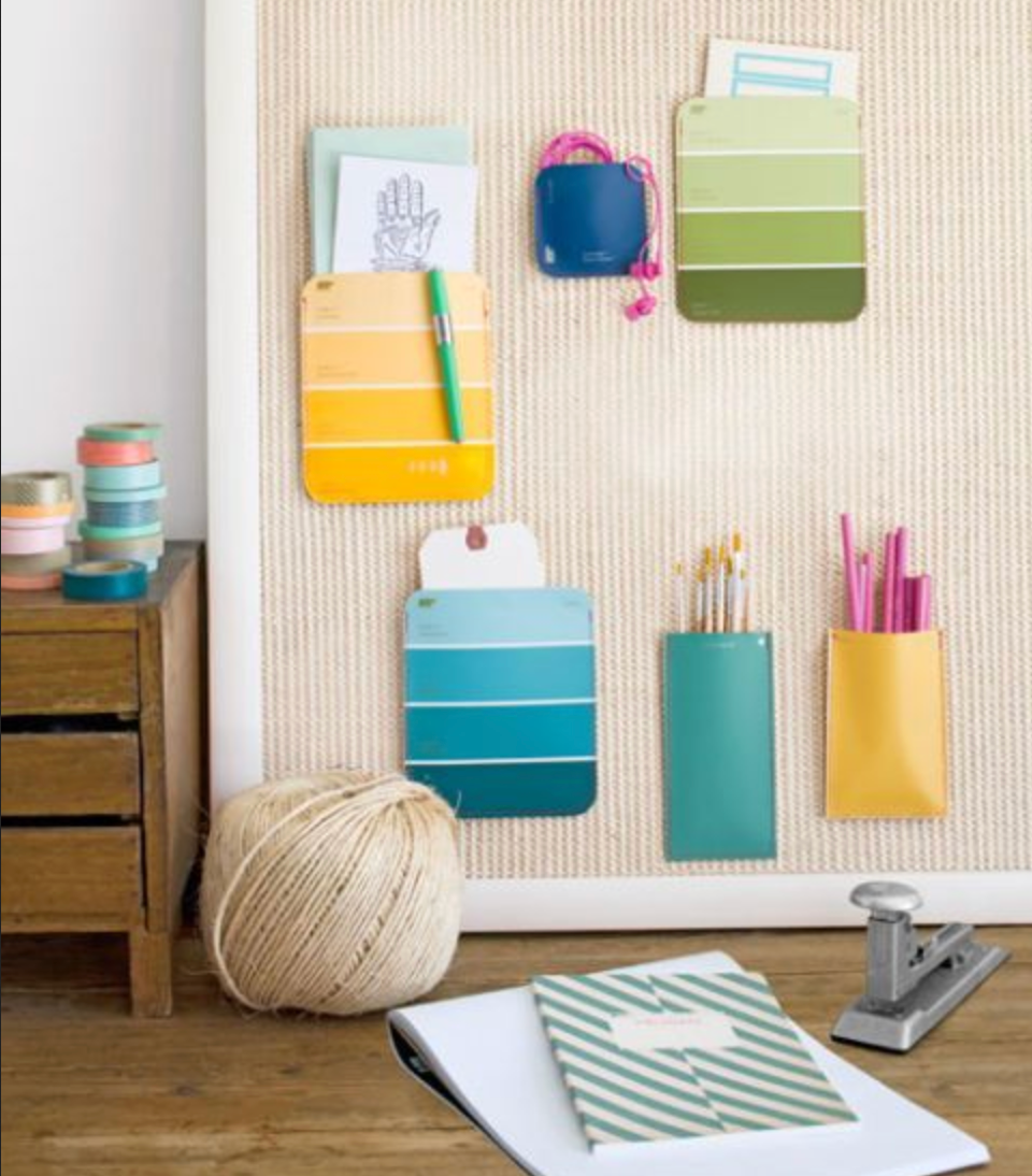 A room with a desk, books, and a basket of things