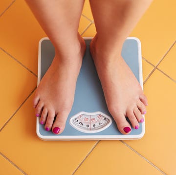 pair of female feet on a bathroom scale